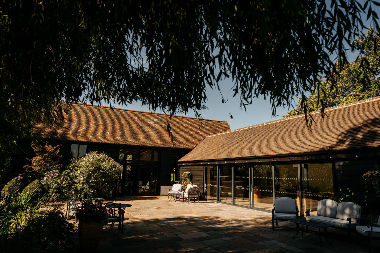The courtyard areacat High House weddings in the summer with blue skies. 